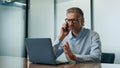 Serious businessman talking mobile phone in office. Director calling telephone Royalty Free Stock Photo