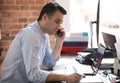 Serious businessman talking on phone having busy working day Royalty Free Stock Photo