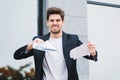 Serious businessman tearing contract in pieces. Angry furious male office worker throwing crumpled paper, having nervous Royalty Free Stock Photo