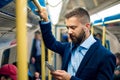 Serious businessman travelling to work. Standing inside underground wagon. Royalty Free Stock Photo