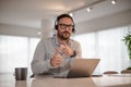 Serious businessman wearing headset gesturing while working at office Royalty Free Stock Photo