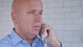 Businessperson Image Talking to Telephone in Office