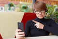 Serious businesswoman in eyeglasses during online video call. Royalty Free Stock Photo