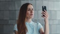 Serious businesswoman having video chat on smartphone at city street Royalty Free Stock Photo