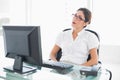 Serious businesswoman sitting at her desk looking at computer Royalty Free Stock Photo