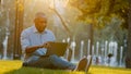 Serious busy African American man businessman freelancer user with laptop work distant online browsing computer sitting Royalty Free Stock Photo