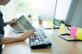 Serious busy hipster young web software developer programmer is coding or programming on a desktop computer information in modern Royalty Free Stock Photo