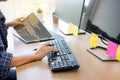 Serious busy hipster young web software developer programmer is coding or programming on a desktop computer information in modern Royalty Free Stock Photo