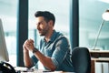 Serious, busy and thinking business man working at his computer desk alone inside a modern office near a window. Worried Royalty Free Stock Photo