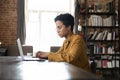 Serious busy young Black laptop user woman working at computer