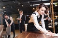 Busy waitress preparing restaurant for open and making cleanup