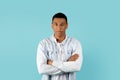 Serious calm confident handsome young african american male student with crossed arms on chest Royalty Free Stock Photo