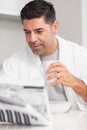 Serious casual man with coffee cup reading newspaper Royalty Free Stock Photo