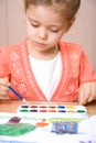 Serious caucasian child watercolor paint