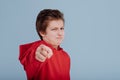 Serious child boy pointing at camera in studio Royalty Free Stock Photo