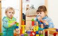 Serious children playing with blocks