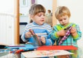 Serious children playing with pencils