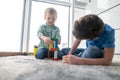 Two boys playing with toy blocks in a room Royalty Free Stock Photo