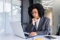 Serious concentrated and thinking businesswoman inside office at workplace typing on laptop, female boss working with Royalty Free Stock Photo