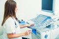 Serious, concentrated young doctor, specialist using Ultrasound Scanning Machine for pacient testing. Copy space. Selective focus Royalty Free Stock Photo