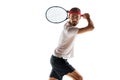 Serious and concentrated young man, tennis player during game, standing with racket, ready to hit ball isolated over Royalty Free Stock Photo