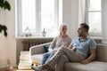 Serious concerned senior couple talking on home couch Royalty Free Stock Photo