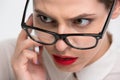 Serious conentrated business woman in glasses talking on cell phone Royalty Free Stock Photo