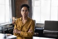 Serious confident African businesslady pose cross-armed in company office