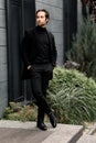 Serious confident business man in stylish suit standing outside the office, looking at the side. Handsome successful Royalty Free Stock Photo