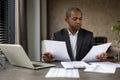 Serious confident businessman financier inside office at workplace checking documents, reports and contracts. Senior man Royalty Free Stock Photo