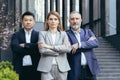 Serious and confident female boss with team of workers, group of business people outside office Royalty Free Stock Photo