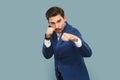 Serious confident man with clenched fists, being ready boxing, looking at camera with angry look. Royalty Free Stock Photo