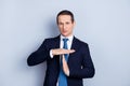 Serious, confident man in formalwear with tie showing cut, time Royalty Free Stock Photo