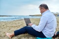 Serious confident mature man with laptop outdoors Royalty Free Stock Photo