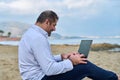 Serious confident mature man with laptop outdoors Royalty Free Stock Photo