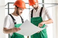 Serious constructors keeping necessary plan Royalty Free Stock Photo
