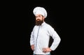 Serious cook in white uniform, chef hat. Portrait of a serious chef cook. Bearded chef, cooks or baker. Bearded male Royalty Free Stock Photo