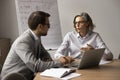 Serious couple of business colleagues talking at table Royalty Free Stock Photo