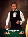 Serious dealer puts the last card on the table Royalty Free Stock Photo