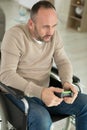 serious disabled man playing computer games during rehabilitation