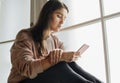 Serious and distressed woman using a smartphone