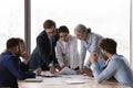 Serious diverse business group discussing project reports at meeting table Royalty Free Stock Photo