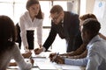 Diverse colleagues talk discuss business project together at meeting Royalty Free Stock Photo