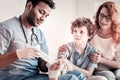 Serious doctor applying bandage on teen foot Royalty Free Stock Photo