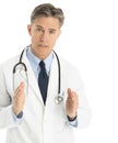 Serious Doctor Gesturing Against White Background