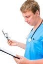 Serious doctor reads the entries in the directory Royalty Free Stock Photo