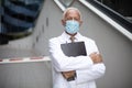 Serious doctor on street wearing protective mask Royalty Free Stock Photo