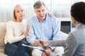 Senior couple talking to financial advisor at home Royalty Free Stock Photo