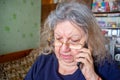 Serious Elderly Jewish Woman Talking on the Phone at Home