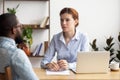 Serious employer listening to African American candidate at job interview Royalty Free Stock Photo